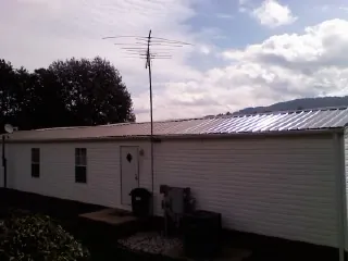 New metal roof on a single wide mobile home with a TV antenna in Warner Robins